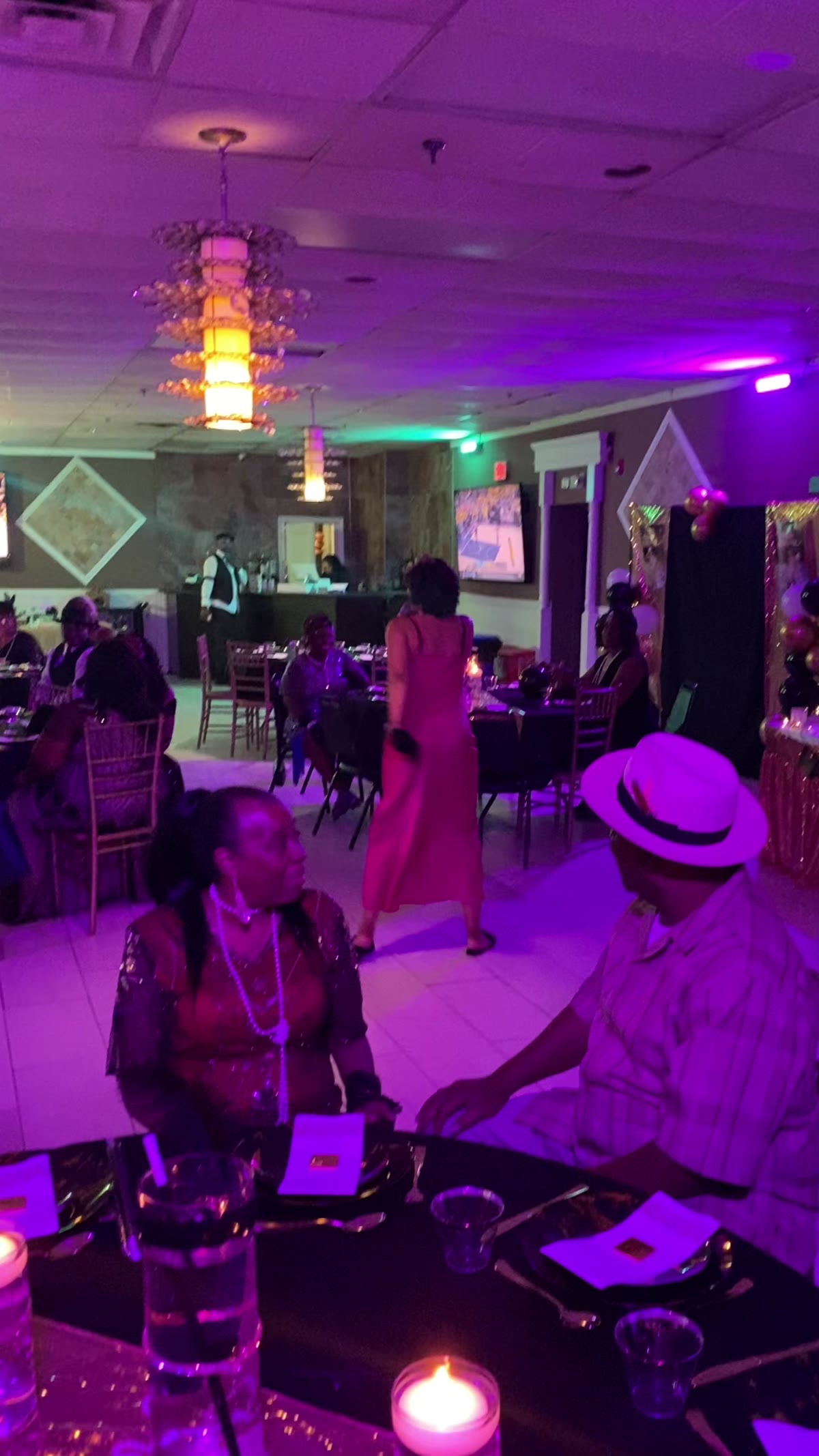 Couple dancing at their wedding reception with guests around them